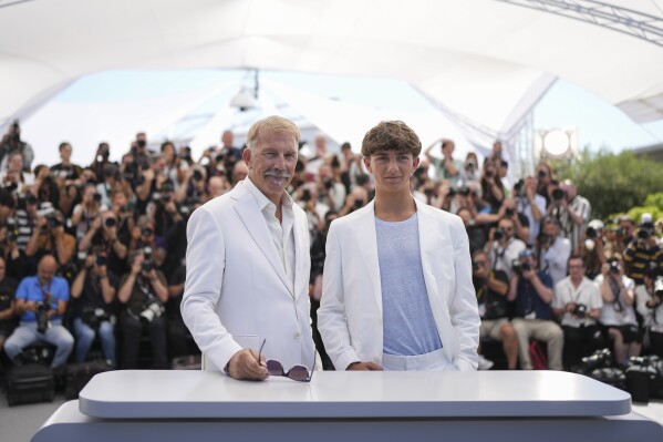 Kevin Costner, left, and Hayes Costner pose for photographers during the photo call for the film 