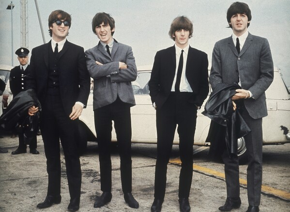 FILE - The Beatles, from left, John Lennon, George Harrison, Ringo Starr and Paul McCartney arrive in Liverpool, England, July 10, 1964, for the premiere of their film 