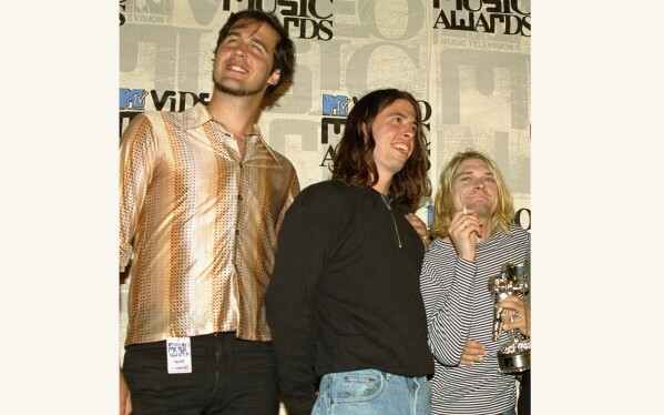 FILE - Nirvana band members Krist Novoselic, from left, Dave Grohl and Kurt Cobain pose after receiving the award for best alternative video for 