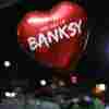 A promotional balloon – inspired by the red heart-shaped balloon from one of Banksy's famous artworks – floats at the opening of The Art Of Banksy exhibition in Miami.