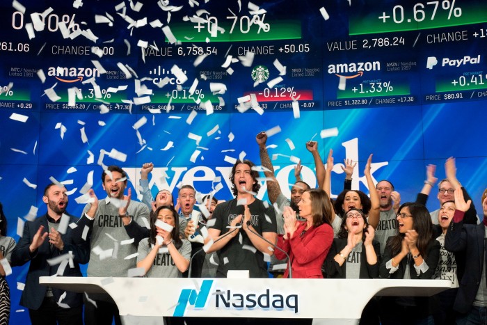 Adam Neumann, center, co-founder and CEO of WeWork, attends the Nasdaq opening ceremony in New York in January 2018