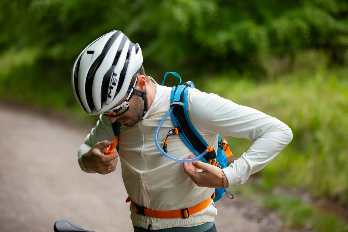 Man wearing hydration vest while riding on gravel