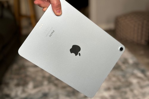 A person holding the iPad Air M2.