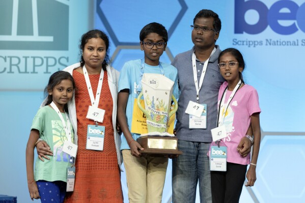 Bruhat Soma, 12, of Tampa, Fla., takes the stage with his family after winning the Scripps National Spelling Bee, in Oxon Hill, Md., Thursday, May 30, 2024. (AP Photo/Mariam Zuhaib)