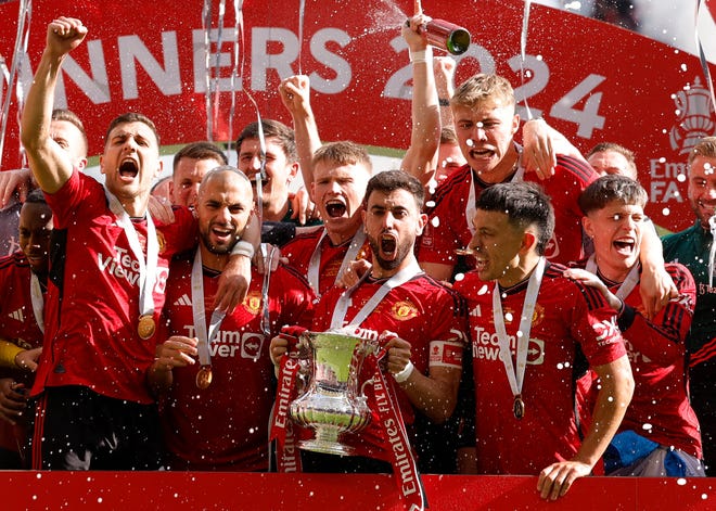 Manchester United players celebrate their victory in the FA Cup final.