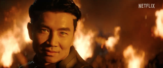 an asian man with blue eyes with flames in the background