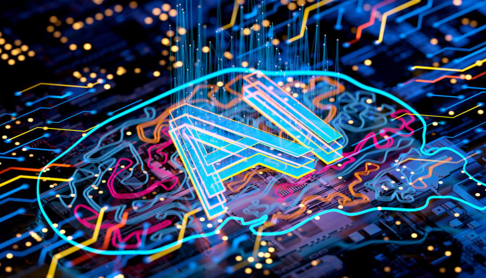 A graphic of a circuit board representing the outline of a brain with the letters AI printed on it.