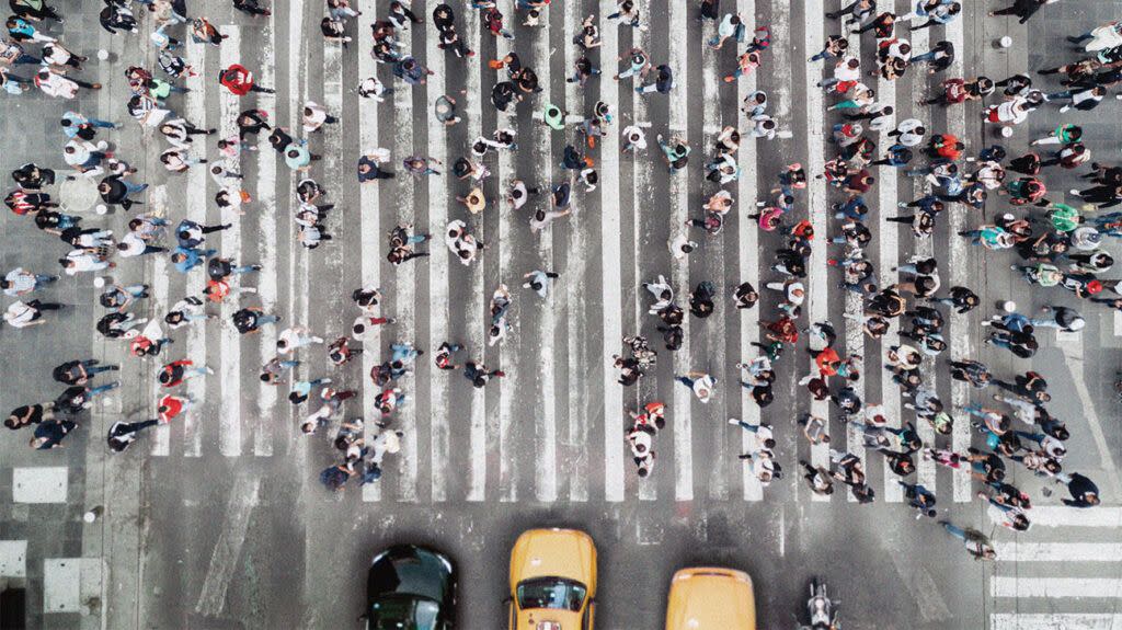 aerial photo of a crowd of people on a large level crossing