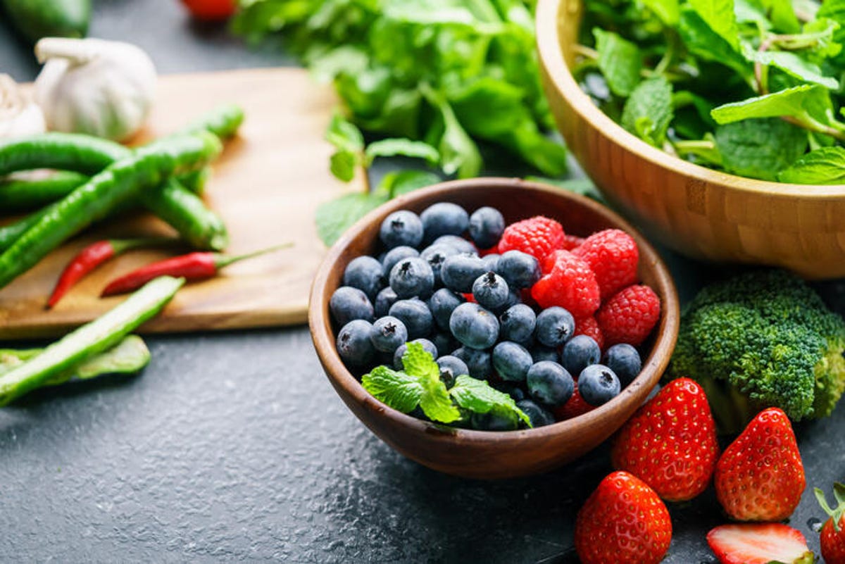 fruits and vegetables in bowls on the table