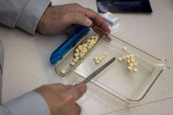 Craig Jones fills a prescription at Basin Pharmacy in Basin, Wyo., Wednesday, Feb. 21, 2024. (AP Photo/Mike Clark)