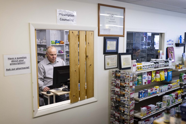 Craig Jones works at Basin Pharmacy in Basin, Wyo., on Wednesday, Feb. 21, 2024. About 25 percent of the prescriptions he fills are reimbursed for less than what he purchased the drugs for.  Jones said he lost $30,000 between the start of the year and mid-May.  (AP Photo/Mike Clark)