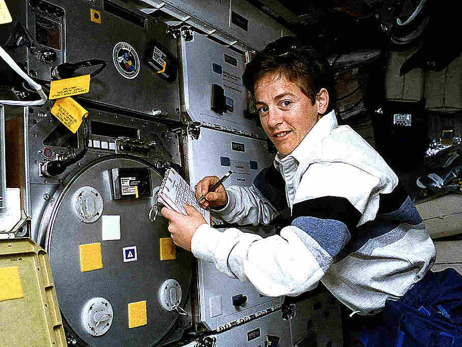 Astronaut Wendy B. Lawrence, flight engineer and mission specialist for STS-67, scribbles notes on the margins of a checklist while monitoring an experiment on the middeck of the Space Shuttle Endeavour.