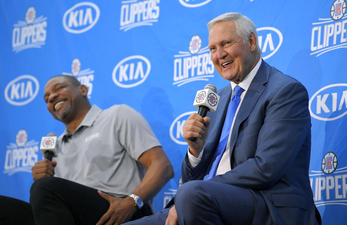 Jerry West speaks during a press conference while Clippers coach Doc Rivers sits next to him and laughs in 2017. 