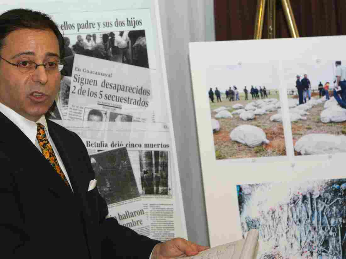 A file photo from 2007 shows lawyer Jonathan Reiter discussing a lawsuit against Chiquita Brands International, speaking alongside newspaper clippings and photos showing stories of alleged torture and killings by paid Colombian paramilitaries by the banana giant.