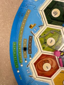 On the side of the Catan: New Energies board, a small black marker indicates the level of greenhouse gases in the current game.