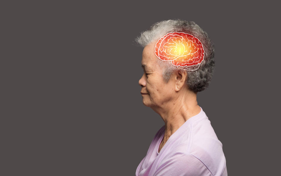 An elderly person is shown in profile with an illustration of a brain highlighted in red and yellow colors, indicating a focus on brain health or activity.