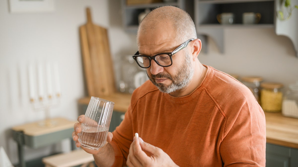 Man taking a pill