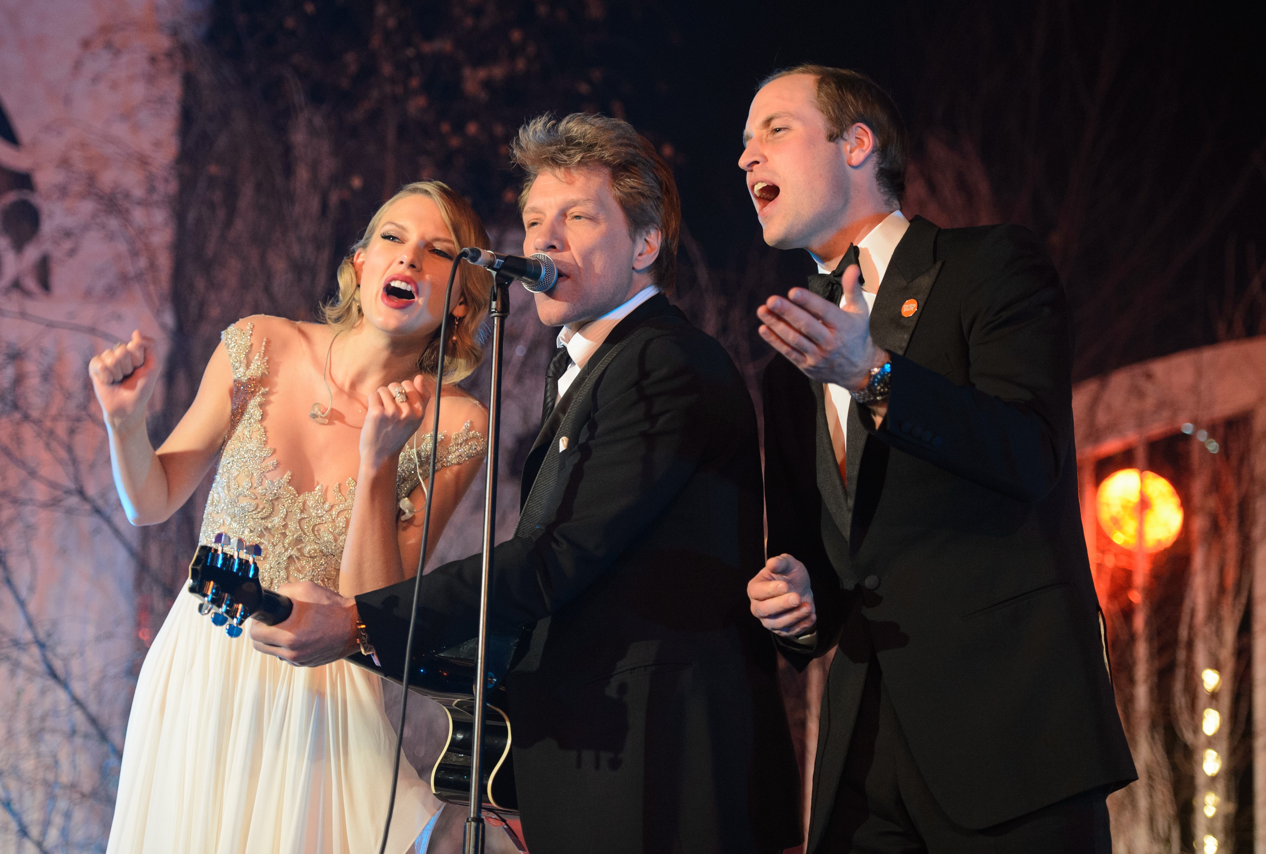 Taylor Swift, Jon Bon Jovi and Prince William sing on stage at the Centrepoint Gala Dinner at Kensington Palace in November 2013.