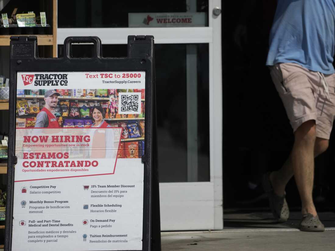 A sign in English and Spanish advertises jobs at a Tractor Supply store in Richland, Mississippi, in 2023.