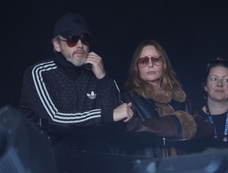 Stella McCartney and her husband Alasdhair Willis watch PJ Harvey perform.