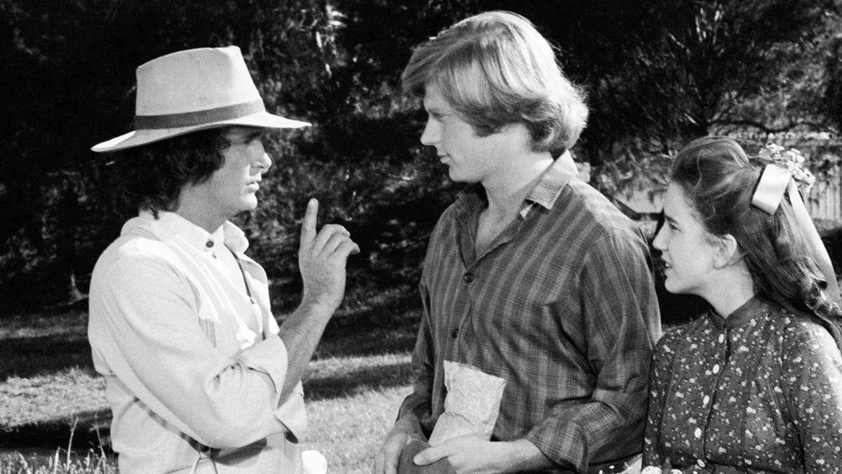 Michael Landon directs Dean Butler under the gaze of Melissa Gilbert.