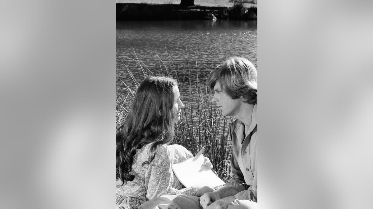 Melissa Gilbert looks in awe at Dean Butler in a field