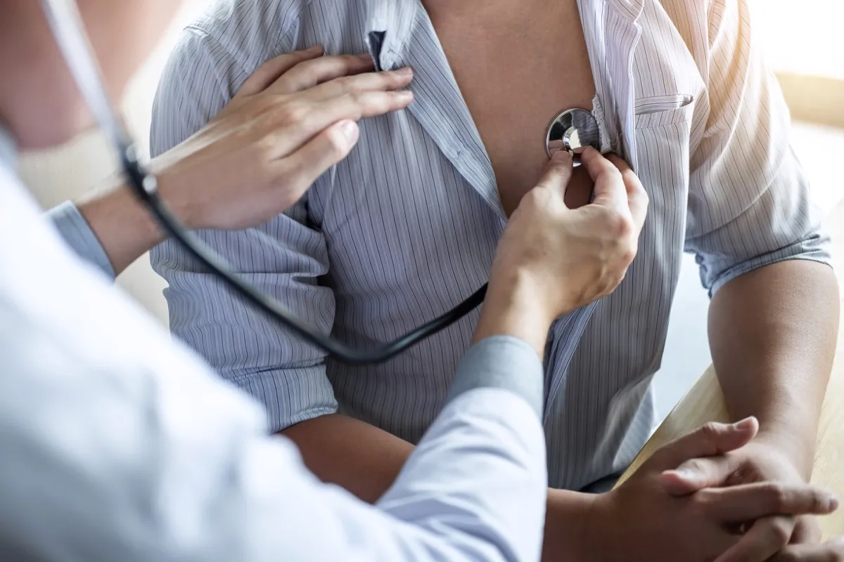 Doctor using stethoscope to check patient by examining them, presenting symptoms results and recommending treatment method, healthcare and medical concept.