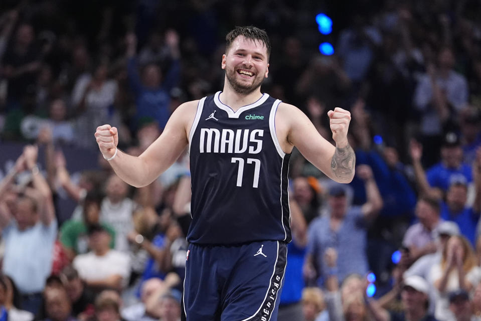 Dallas Mavericks guard Luka Doncic (77) reacts after a play in the first half of Game 4 of the NBA basketball finals against the Boston Celtics, Friday, June 14, 2024, in Dallas.  (AP Photo/Julio Cortés)