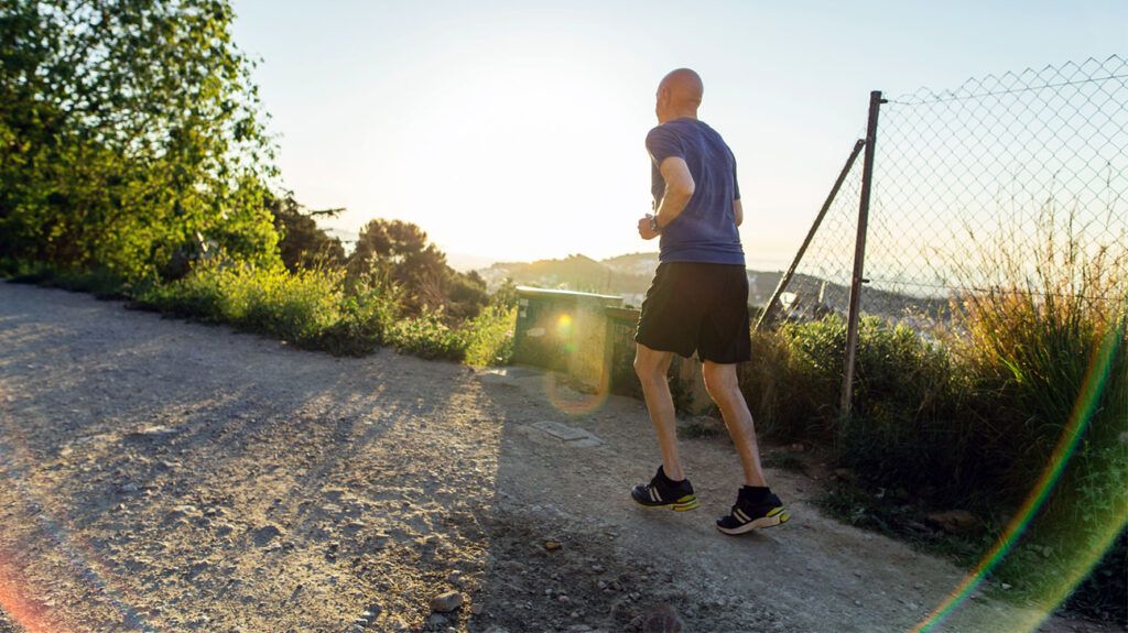 A man running outside on a sunny day