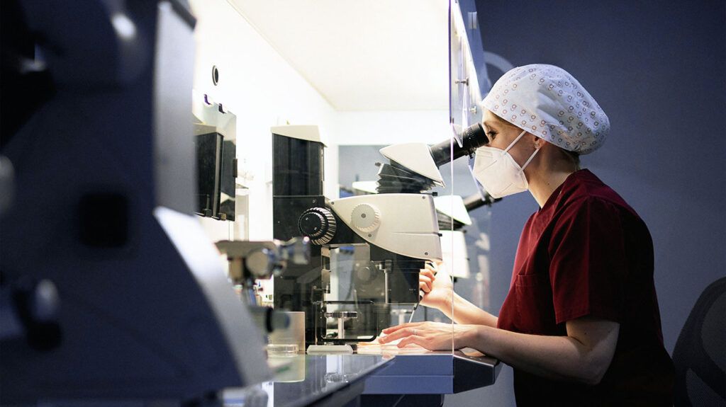 A scientist sitting and analyzing samples in a laboratory