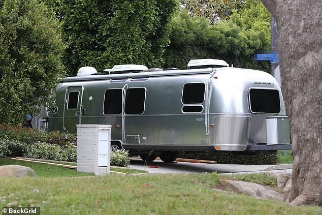 The iconic silver trailer was seen being towed by a van and dropped off near the gate of the star's property.