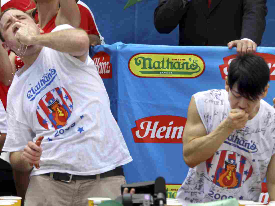 Joey Chestnut (left) and Takeru Kobayashi (right) compete in Nathan's Hot Dog Eating Contest on July 4, 2009.