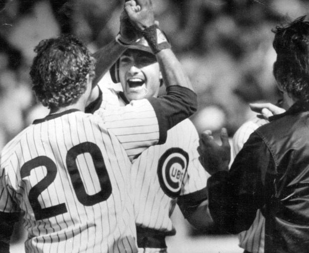 Dave Owen, center, goes after Bob Dernier after Owen's RBI single in the 11th inning gave the Cubs a 12-11 victory over the Cardinals at Wrigley Field on June 23, 1984. (Charles Cherney/ Chicago Tribune)