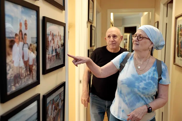 Lynn Oxenberg and her husband, Larry, show off family photos in the hallway of their Elkins Park, Pa. home.