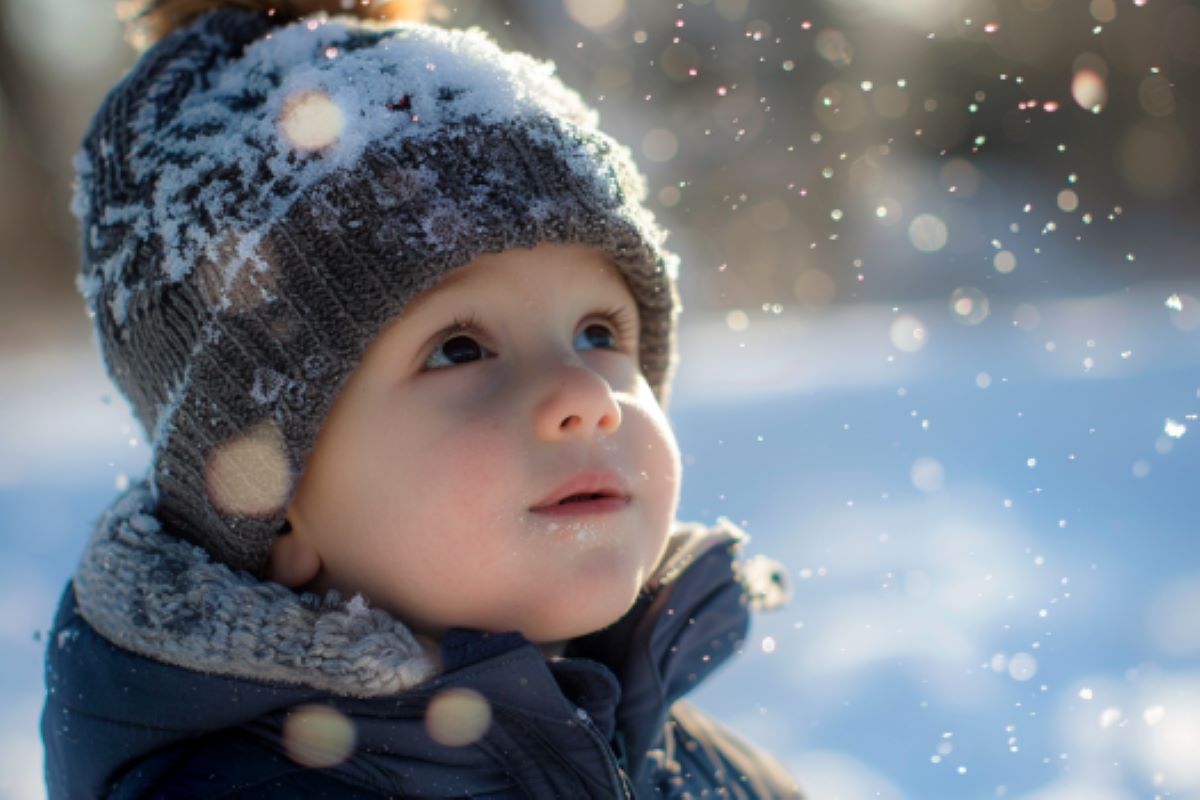 It shows a little boy playing in the snow.