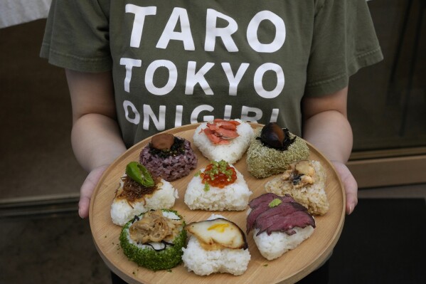 A variety of onigiri, rice balls, are seen on a plate at a Taro Tokyo Onigiri store in Tokyo, June 5, 2024. The word 