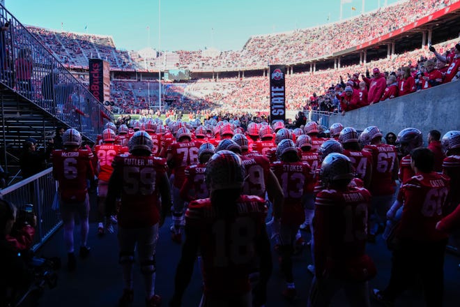 The Ohio State football team takes the field before a game against Minnesota on November 18.