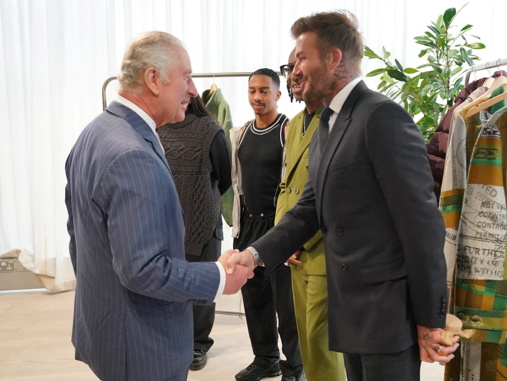 King Charles III shakes hands with David Beckham during a special industry showcase hosted by the British Fashion Council (BFC) at 180 Studios, London on May 18, 2023.