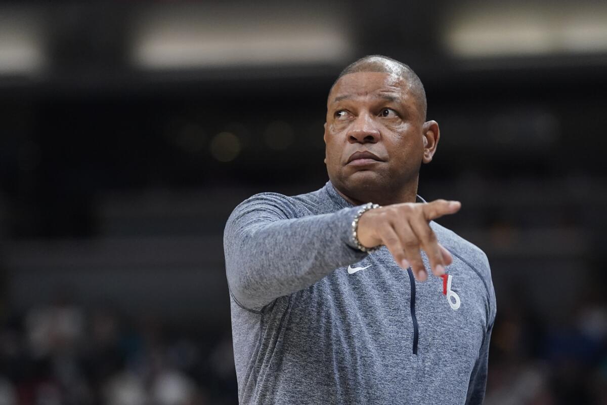 Doc Rivers shows the field as he coaches from the sideline of a game for Philadelphia.