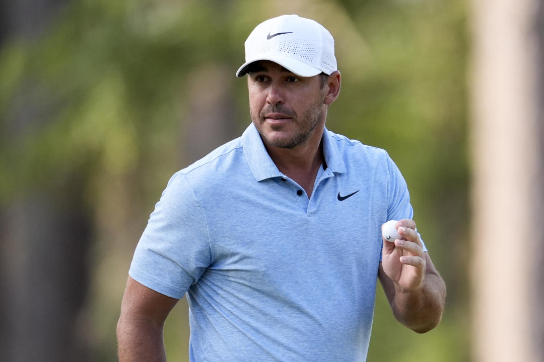 Brooks Koepka salutes after making a putt on the second hole during the first round of the U.S. Open golf tournament, Thursday, June 13, 2024, in Pinehurst, N.C. (AP Photo/George Walker IV)