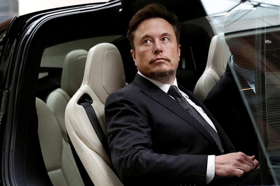 FILE PHOTO: Tesla CEO Elon Musk gets into a Tesla car as he leaves a hotel in Beijing, China May 31, 2023. REUTERS/Tingshu Wang/File Photo