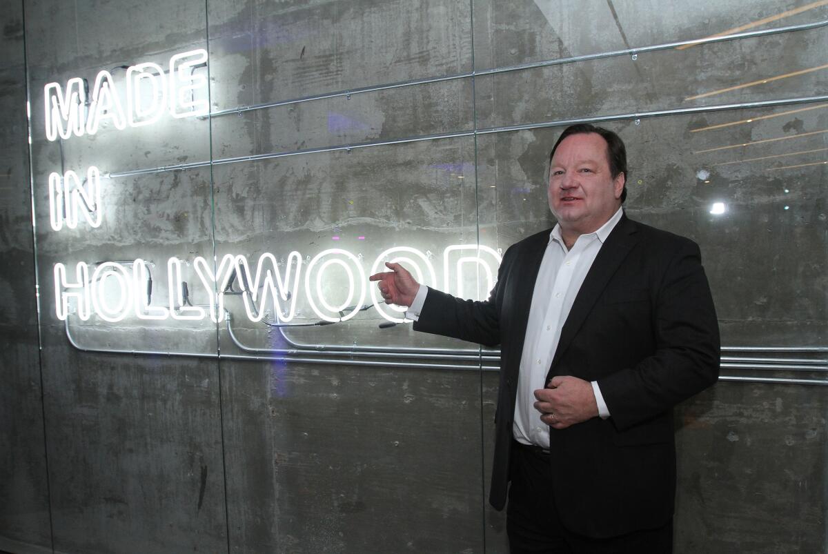 A man shows a neon sign 