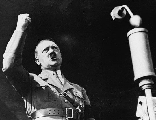 Hitler raises his fist during a speech