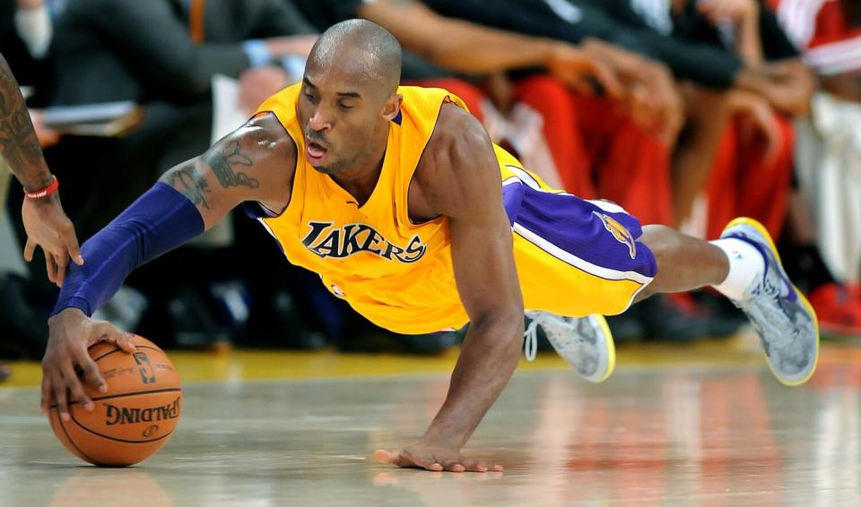 Lakers guard Kobe Bryant dives to recover a loose ball during a 2013 game against the Bucks