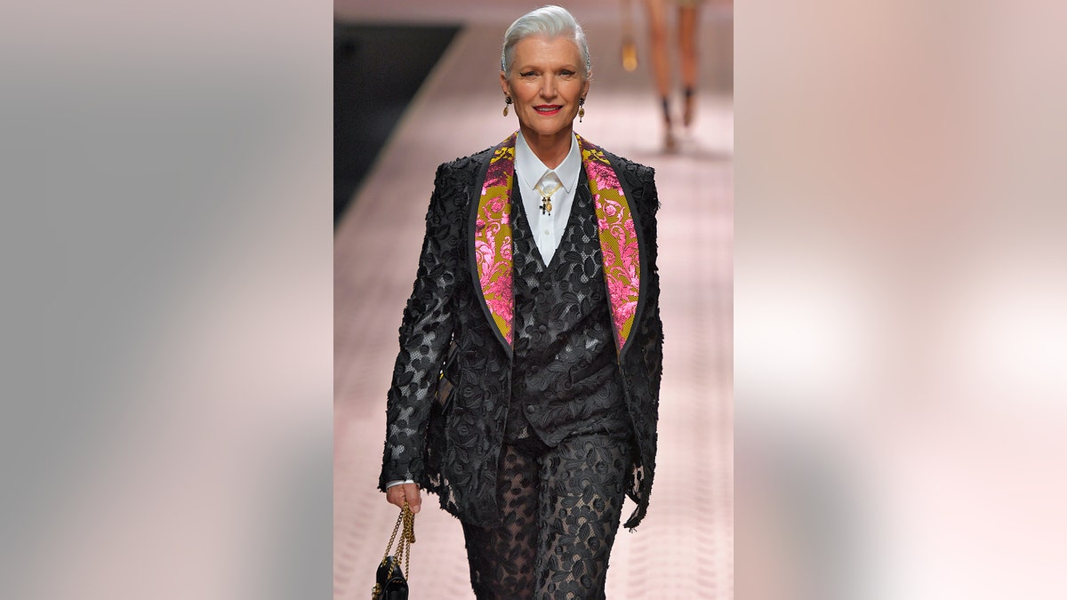 Maye Musk wearing a black suit walking the catwalk