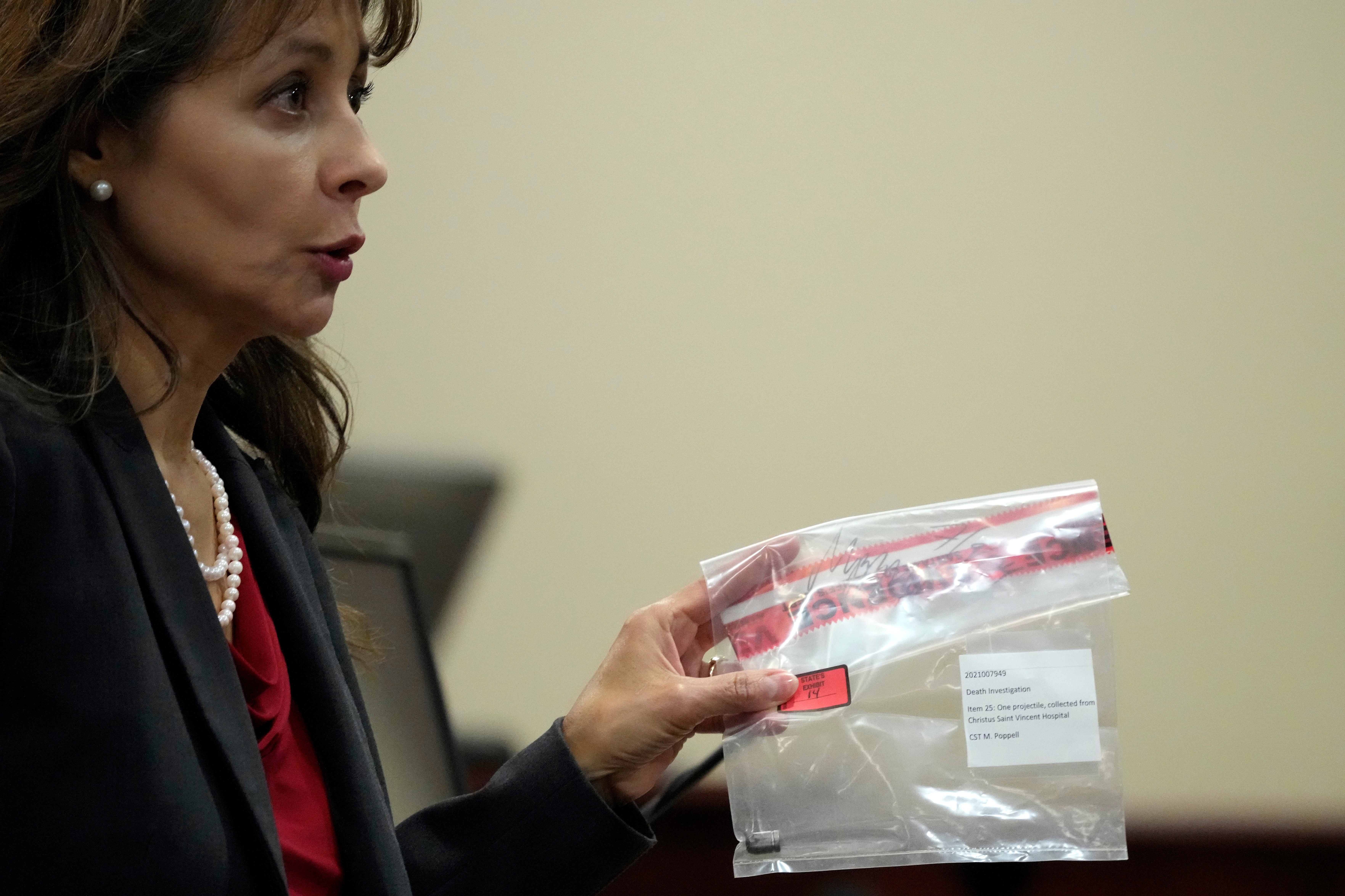 Special Prosecutor Erlinda Ocampo Johnson displays a bullet in an evidence bag during the trial