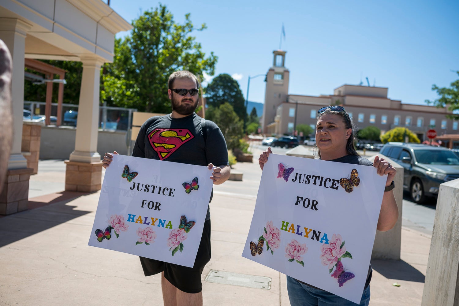 Jonathan Zwiebel, left, and his mother Janelle Rogers stand outside District Court to demand justice for cinematographer Halyna Hutchins