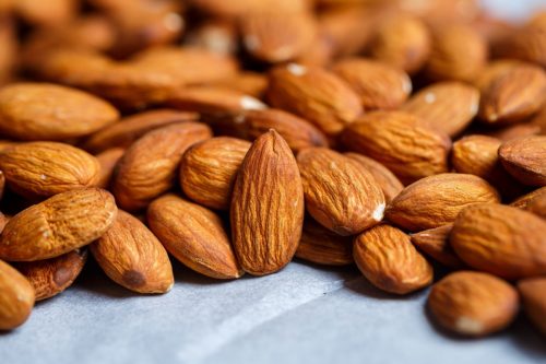 raw almonds on a gray surface