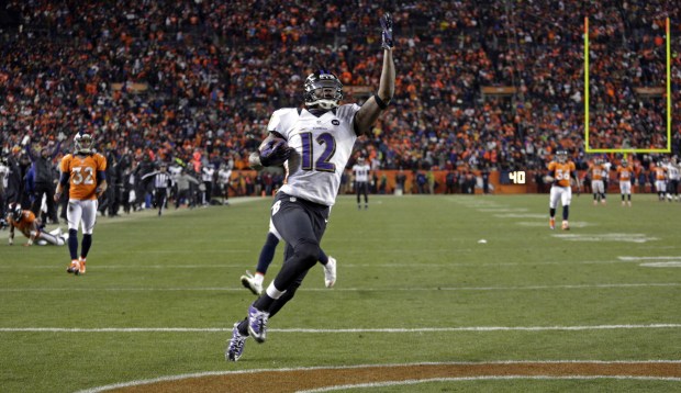 Ravens wide receiver Jacoby Jones celebrates as he runs through the...