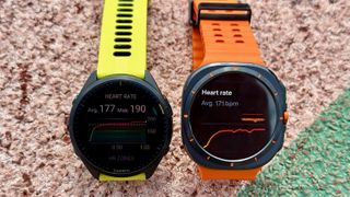 The Samsung Galaxy Watch Ultra (right) and Garmin Forerunner 965 (left) displaying heart rate averages after a track run.